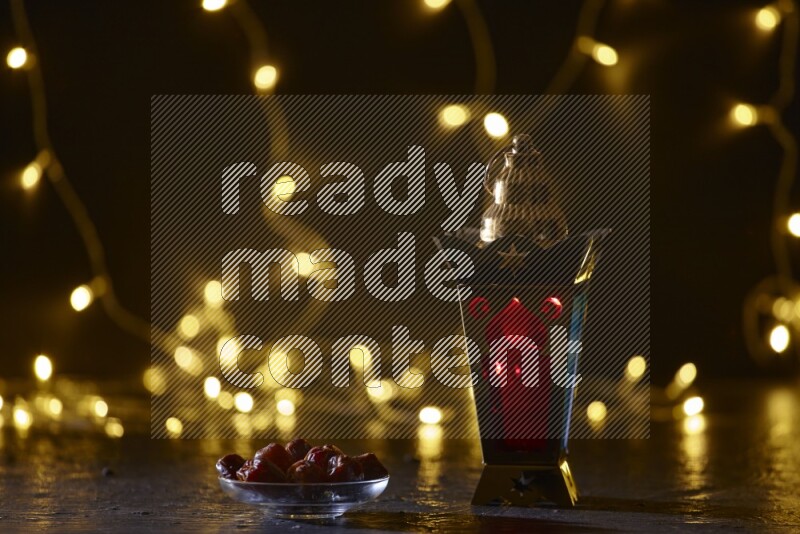A traditional ramadan lantern surrounded by glowing fairy lights in a dark setup