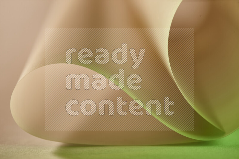 An abstract art piece displaying smooth curves in green and yellow gradients created by colored light