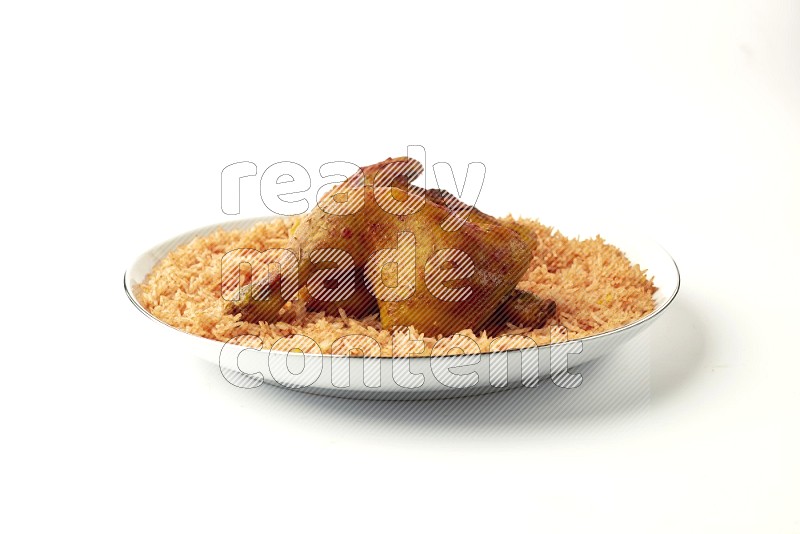 red basmati Rice with  kabsa chicken pieces on a white plate with a silver rim direct  on white background