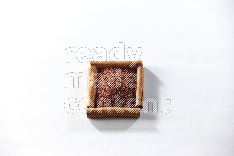 A single square of cinnamon sticks full of garden cress on white flooring