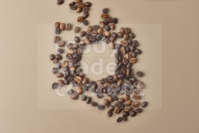 Roasted coffee beans on beige background