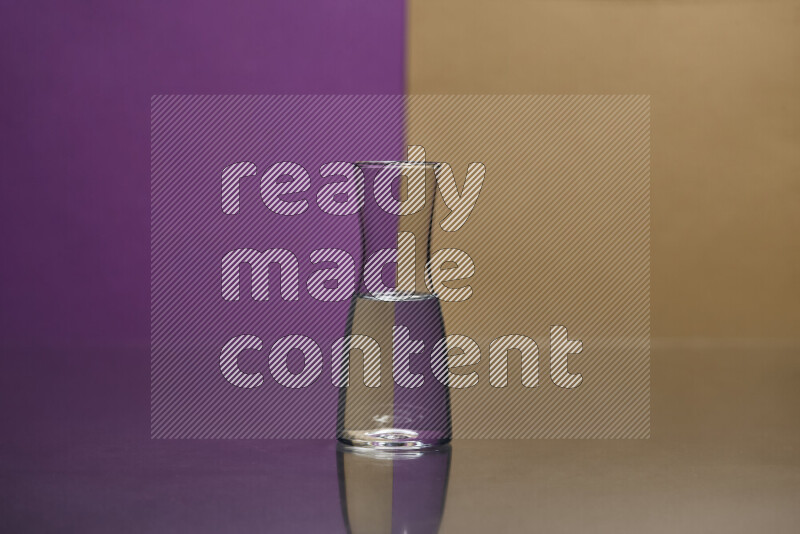 The image features a clear glassware filled with water, set against purple and beige background