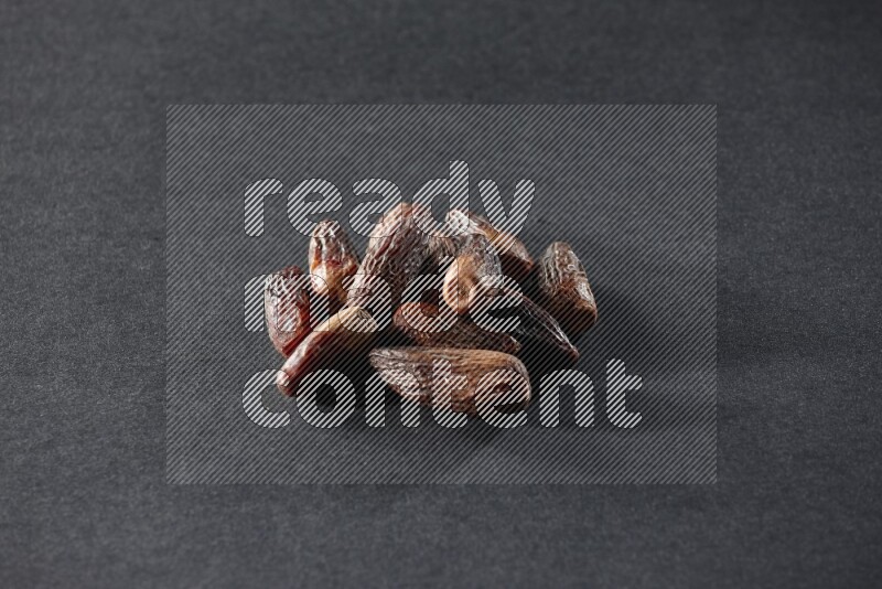 Dried dates on a black background in different angles
