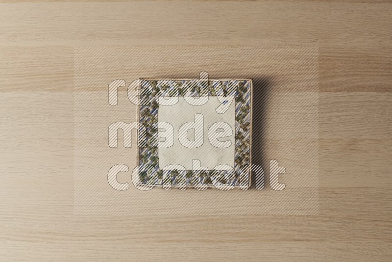 A decorative pottery plate on light wooden background