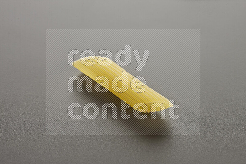 Penne pasta on grey background