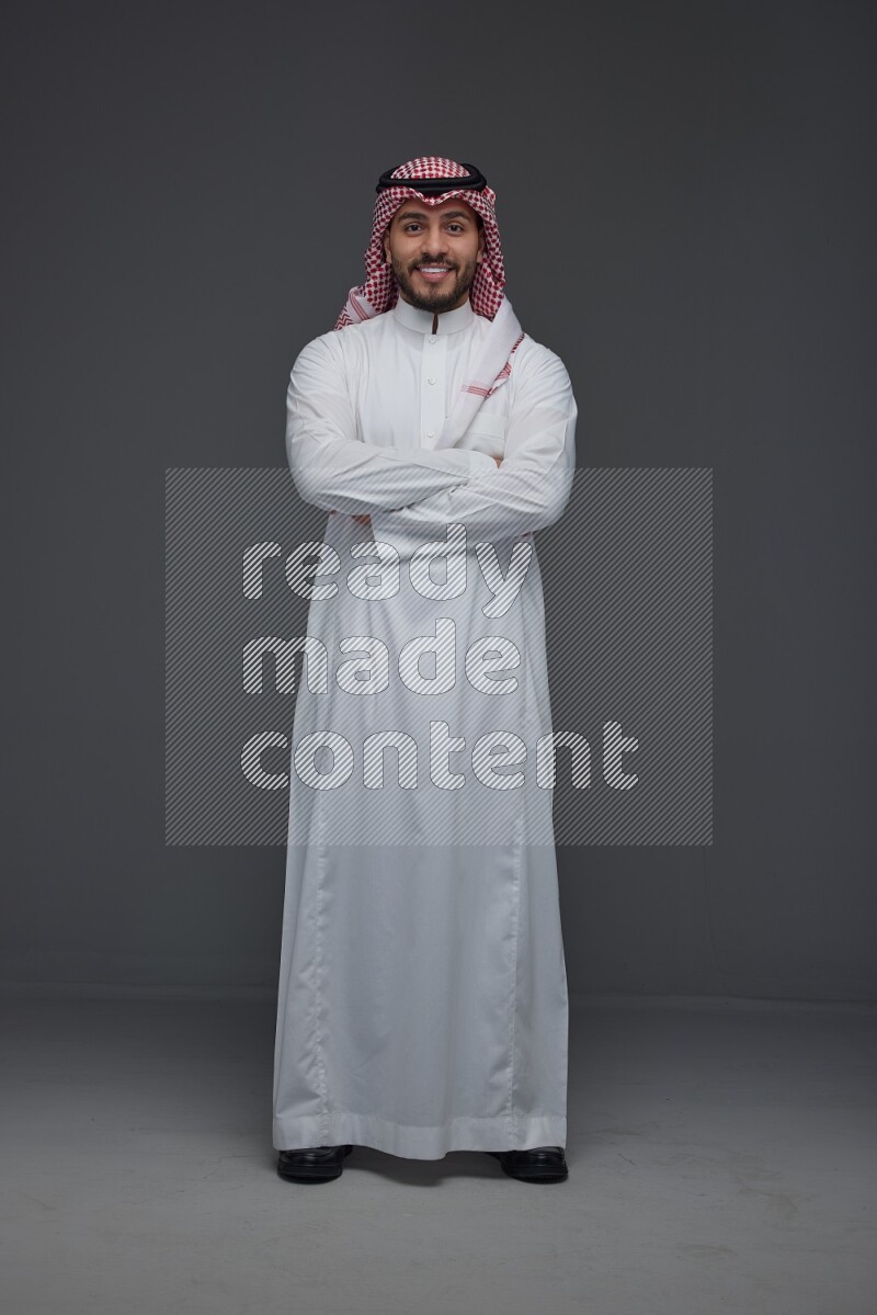 A Saudi man wearing Thobe and Shmagh standing in different poses eye level on a gray background