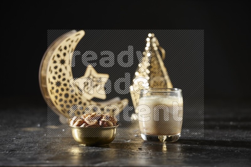 Nuts in a metal bowl with Nuts smoothie beside golden lanterns in a dark setup