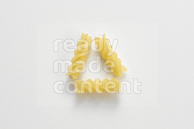 Fusilli pasta on white background