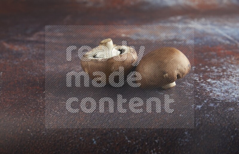 45 degre cremini  mushrooms on a textured reddish rustic metal background