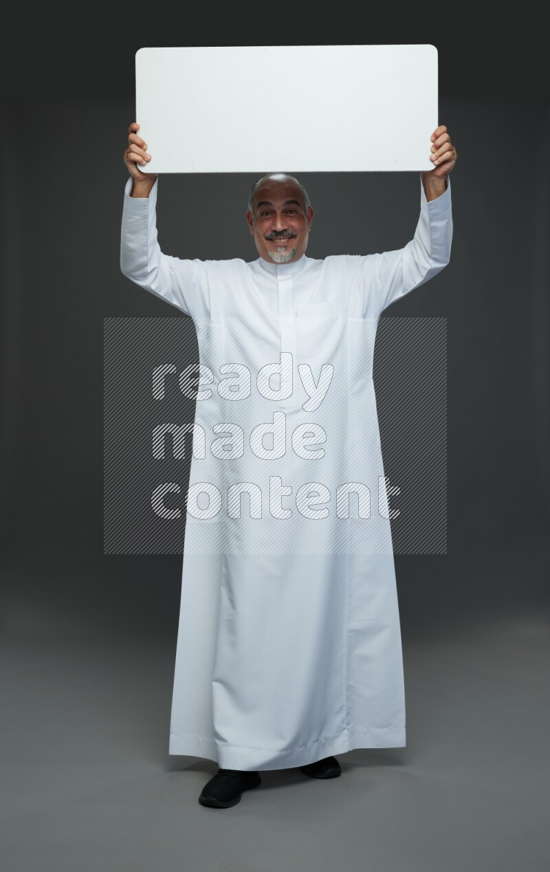 Saudi man without shomag Standing holding social media sing on gray background