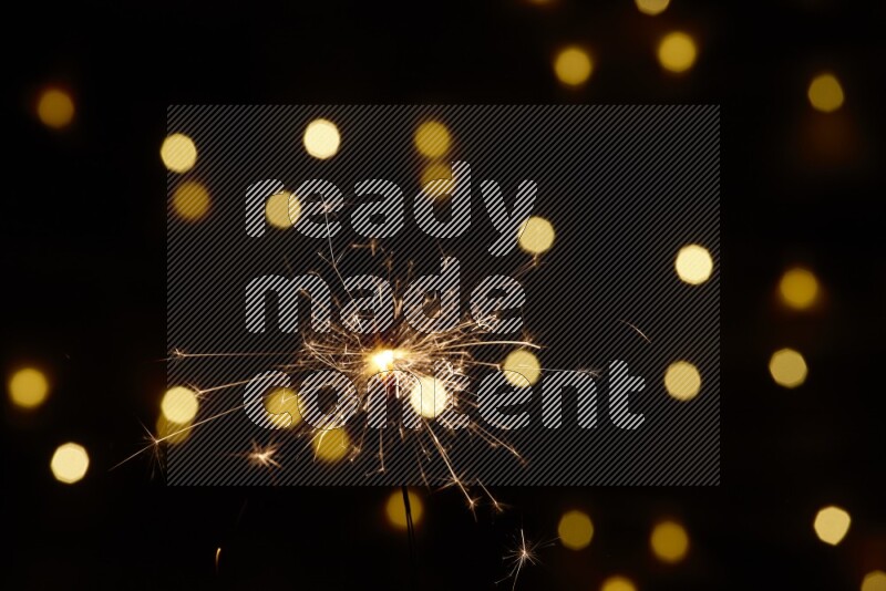 Sparkler candle with yellow light bokeh background