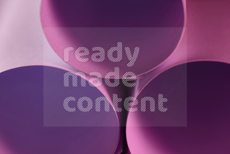 The image shows an abstract paper art with circular shapes in varying shades of pink