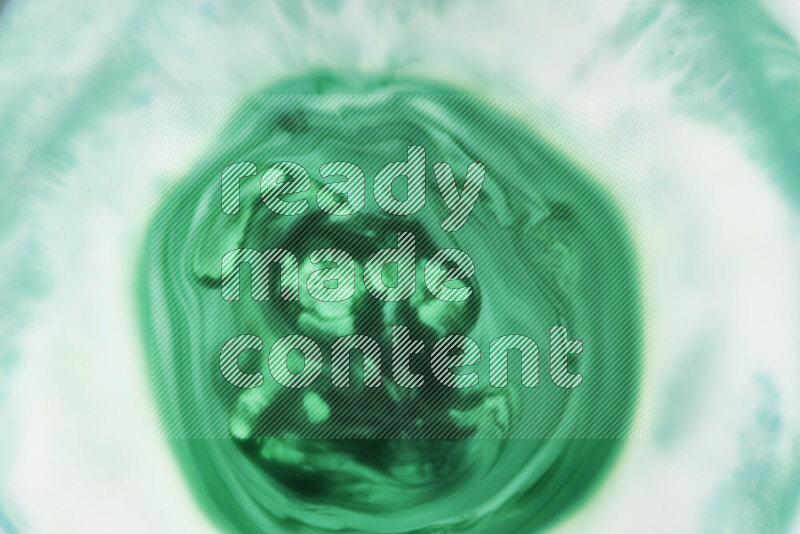 A close-up of abstract swirling patterns in green gradients