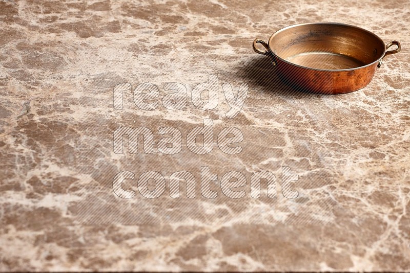 Small Copper Pan on Beige Marble Flooring, 45 degrees