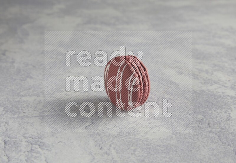 45º Shot of Red Poppy Flower macaron on white  marble background