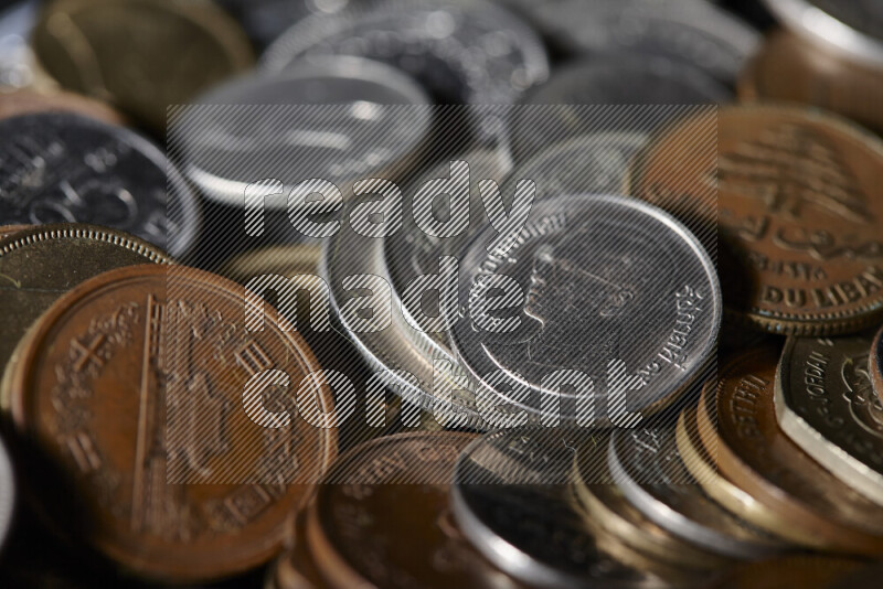 A close-ups of random old coins on black background