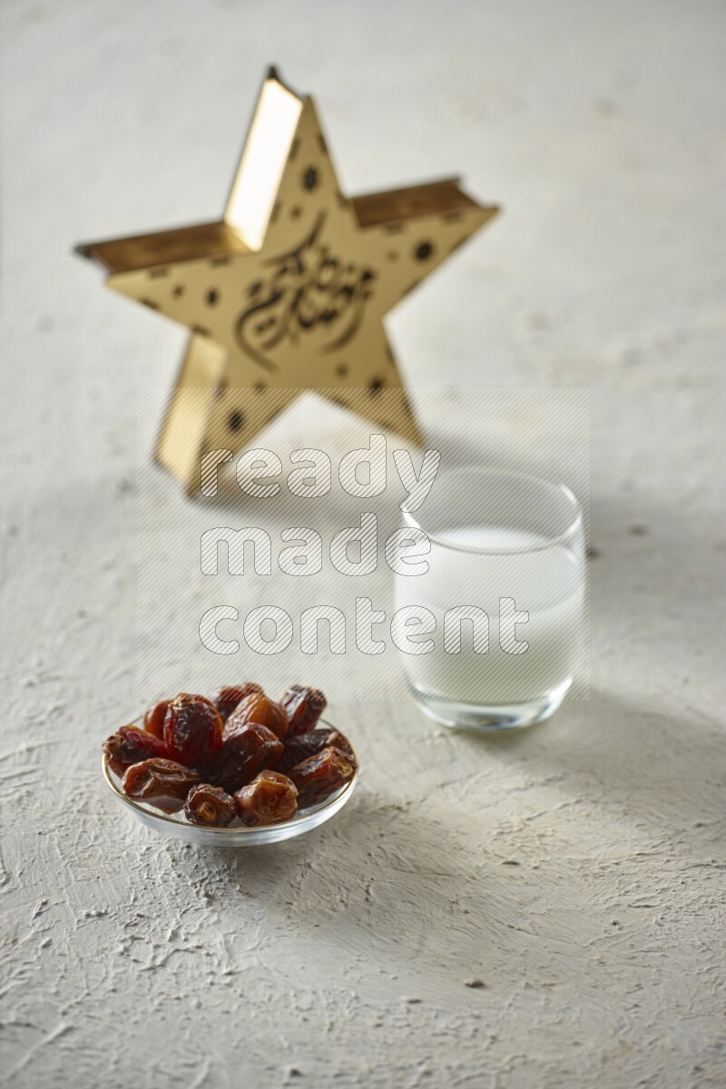 A wooden golden star lantern with different drinks, dates, nuts, prayer beads and quran on textured white background