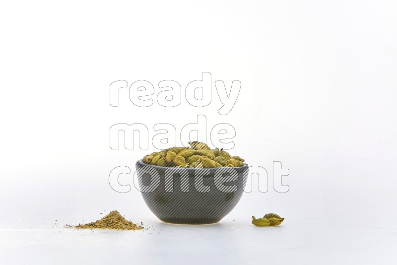 Cardamon in a container on white background