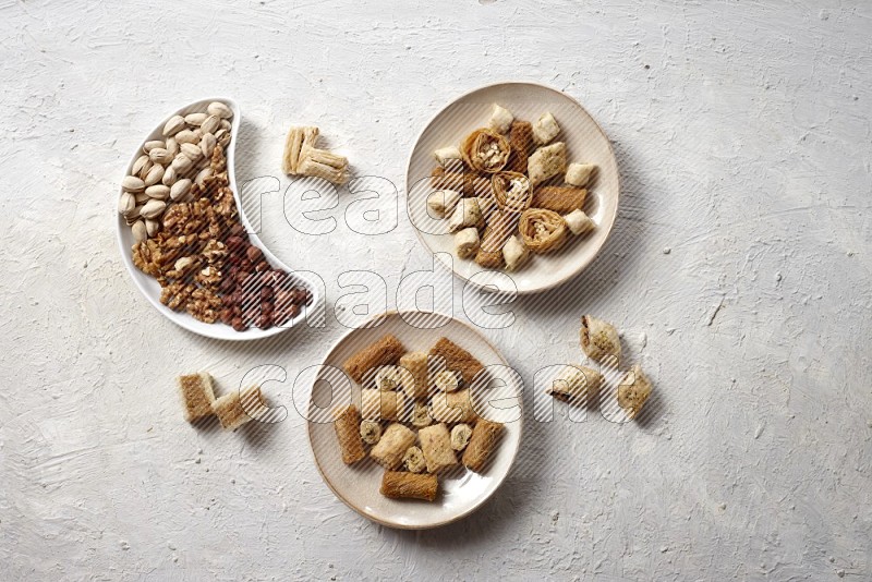Oriental sweets in pottery plates with nuts in a light setup