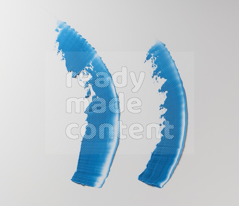 Blue curved painting knife strokes on white background