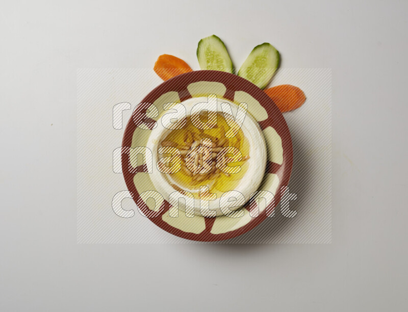 Lebnah garnished with pine nuts in a traditional plate on a white background