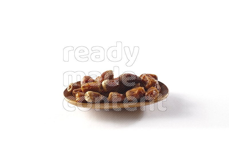 Dates in a wooden plate on white background