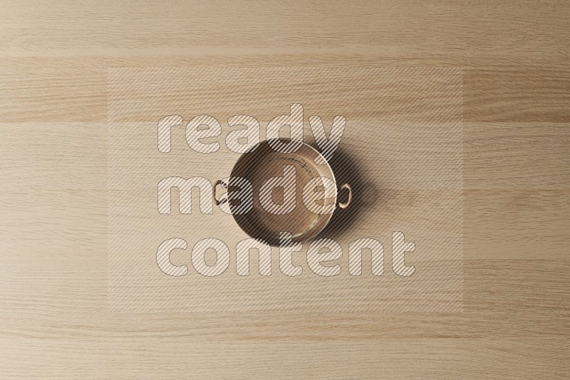 Top View Shot Of A Small Copper Pan on Oak Wooden Flooring