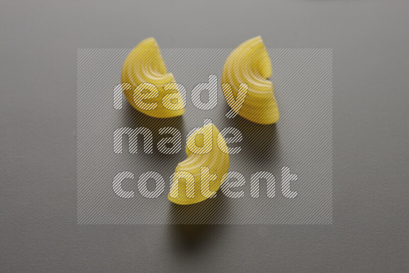Elbow pasta on grey background