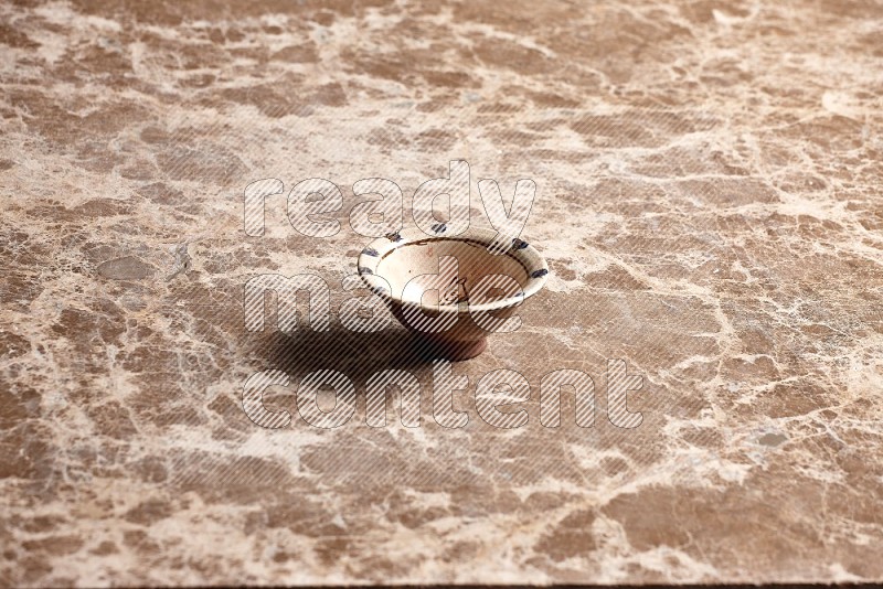 Decorative Pottery Bowl on Beige Marble Flooring, 45 degrees