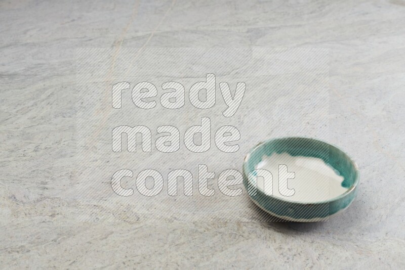 A multicolored pottery bowl on grey marble background