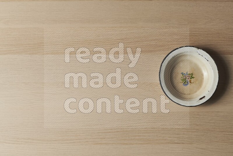 A vintage metal plate on light wooden background