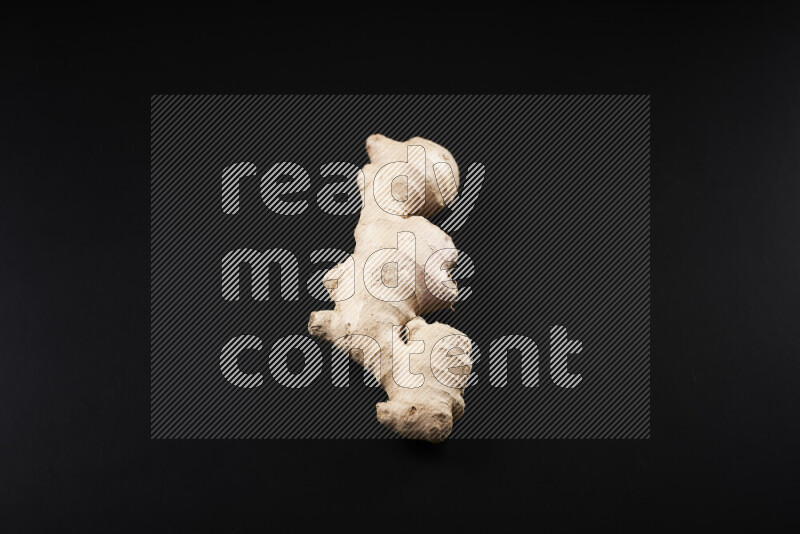 Fresh ginger root on black background