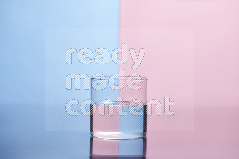 The image features a clear glassware filled with water, set against light blue and rose background