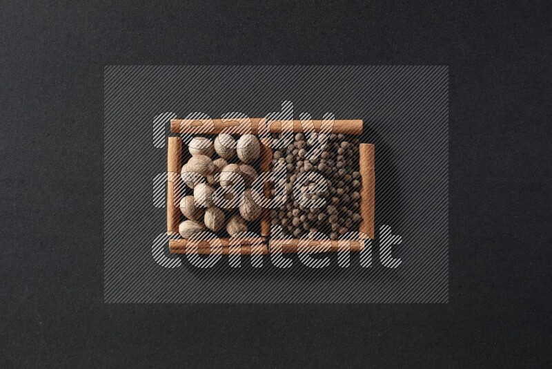 2 squares of cinnamon sticks full of nutmegs and allspice on black flooring