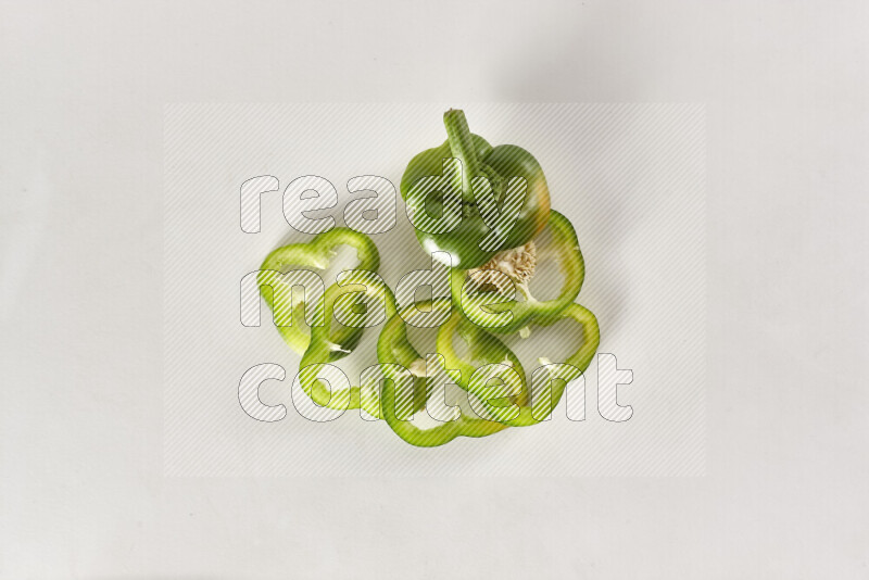 Green bell pepper slices on white background