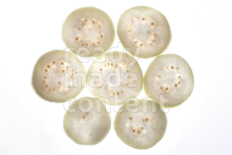 Guava slices on illuminated white background