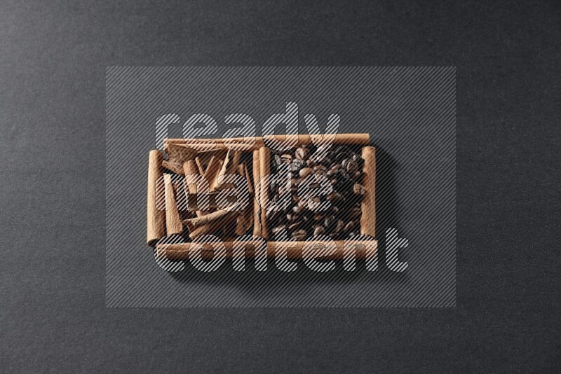 2 squares of cinnamon sticks full of coffee beans and cinnamon on black flooring