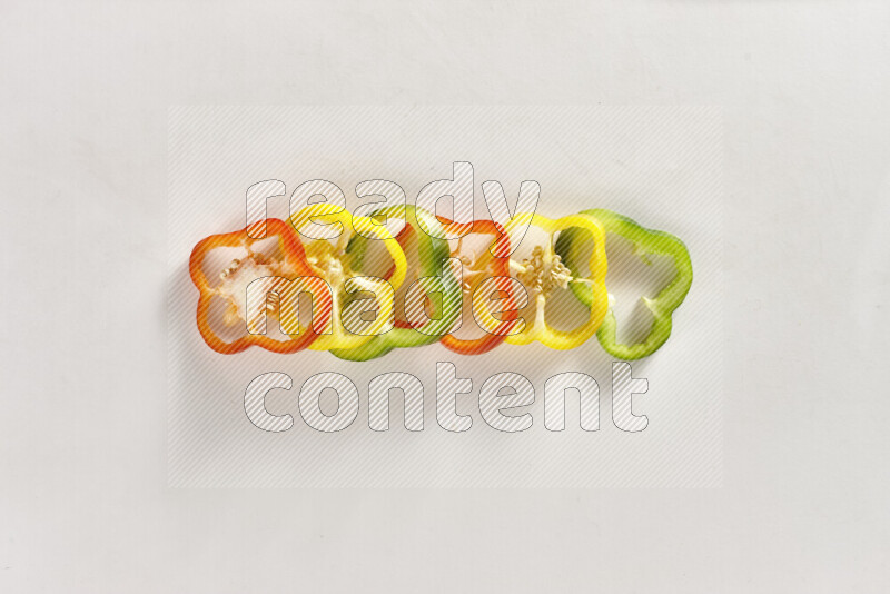 Assorted bell pepper slices on white background