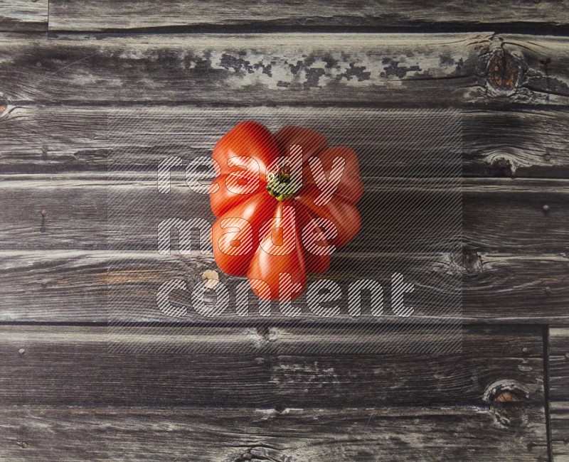 Single Tipview Heirloom Tomato on grey wooden background