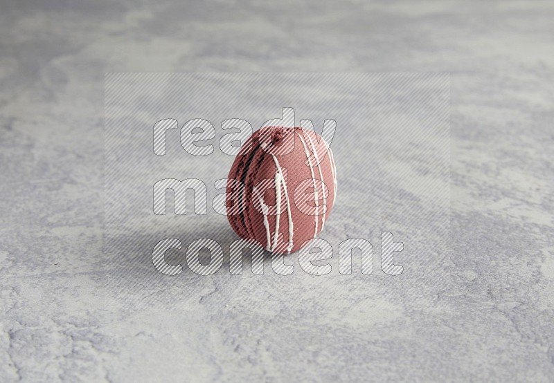 45º Shot of Red Poppy Flower macaron on white  marble background