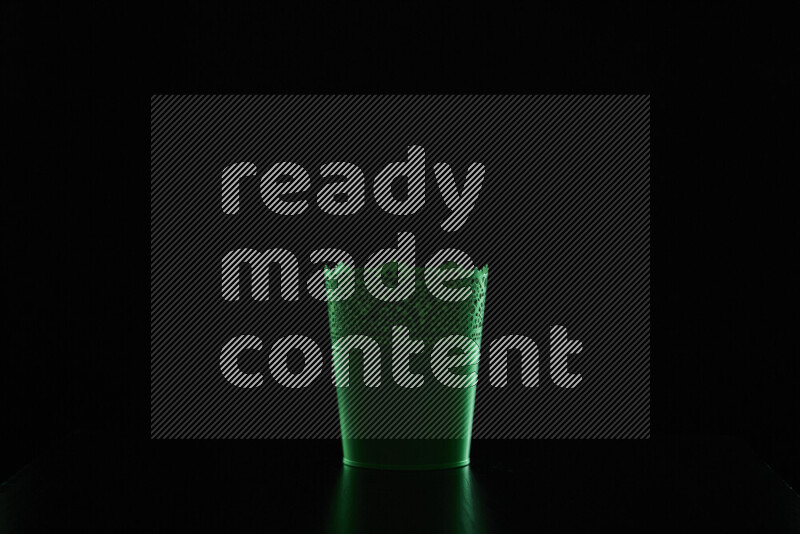 A plant pot with colored rim light against black background