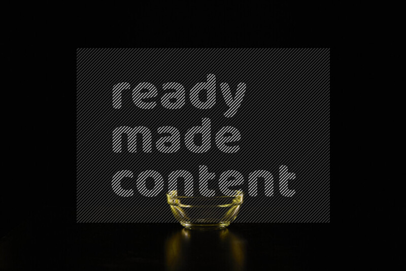 Glassware with rim light in yellow against black background