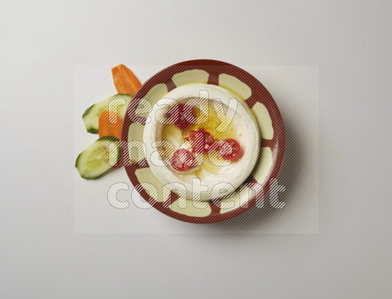 Lebnah garnished with Cherry tomato in a traditional plate on a white background