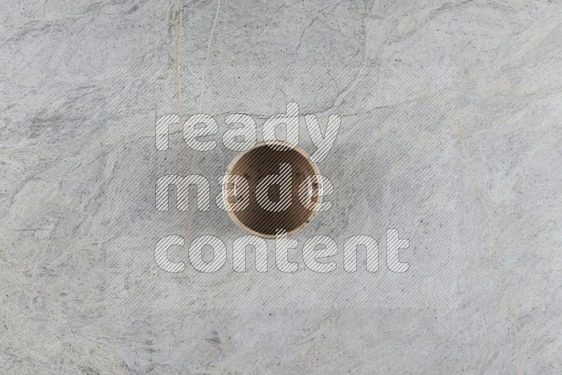 Top View Shot Of A Multicolored Pottery Bowl On Grey Marble Flooring