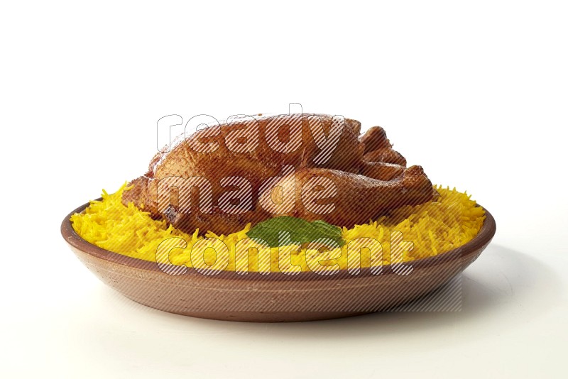 yellow basmati Rice with whole roasted chicken  on a pottery plate  direct  on white background
