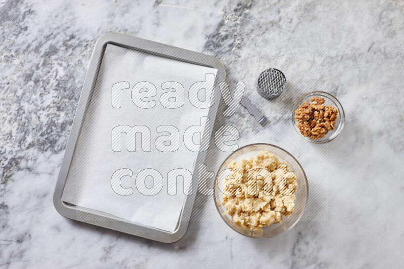 Kahk step by step with its ingredients ghee, sugar, flour, sesame, yeast, water and kahk flavor on grey marble background