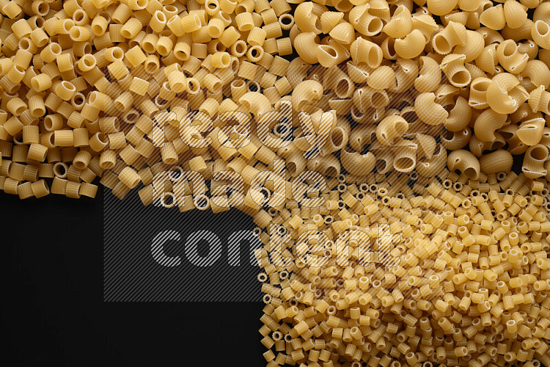 Different pasta types on black background