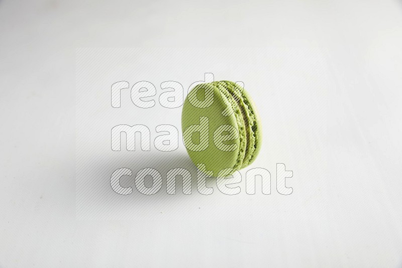 45º Shot of Green Pistachio macaron on white background