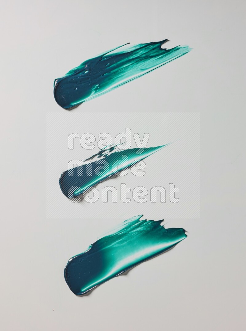 Turquoise painting knife strokes on white background