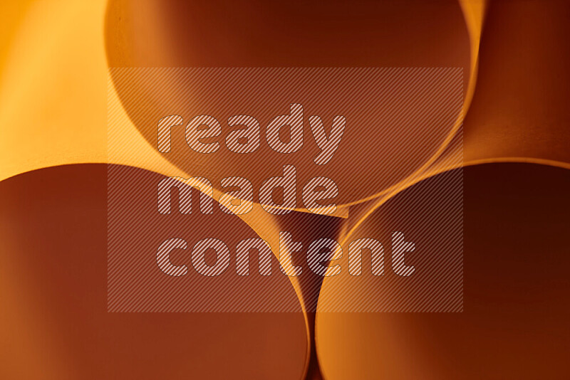 The image shows an abstract paper art with circular shapes in varying shades of orange